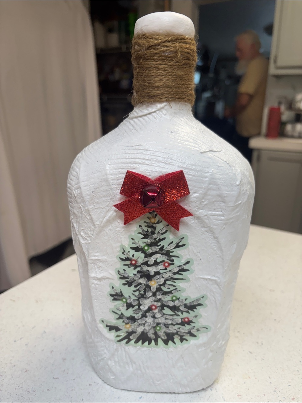 White Decorative Holiday Bottle with Red Bow and Christmas Tree Accent